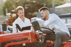 two men looking at a lawn tractor